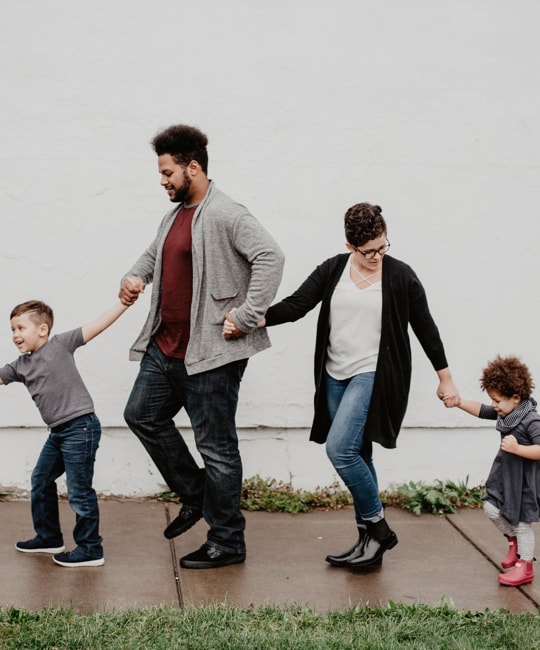 family holding their children